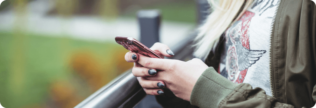 Woman's hands holding cell phone