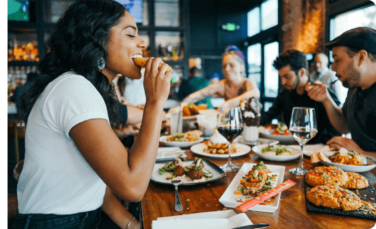 woman eating at resturant with group of friends