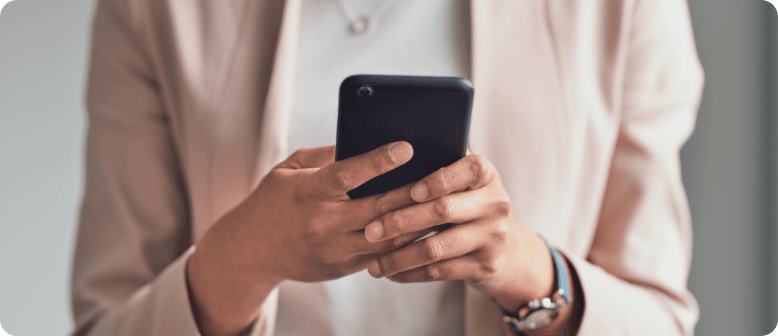Woman in suit looking at cell phone