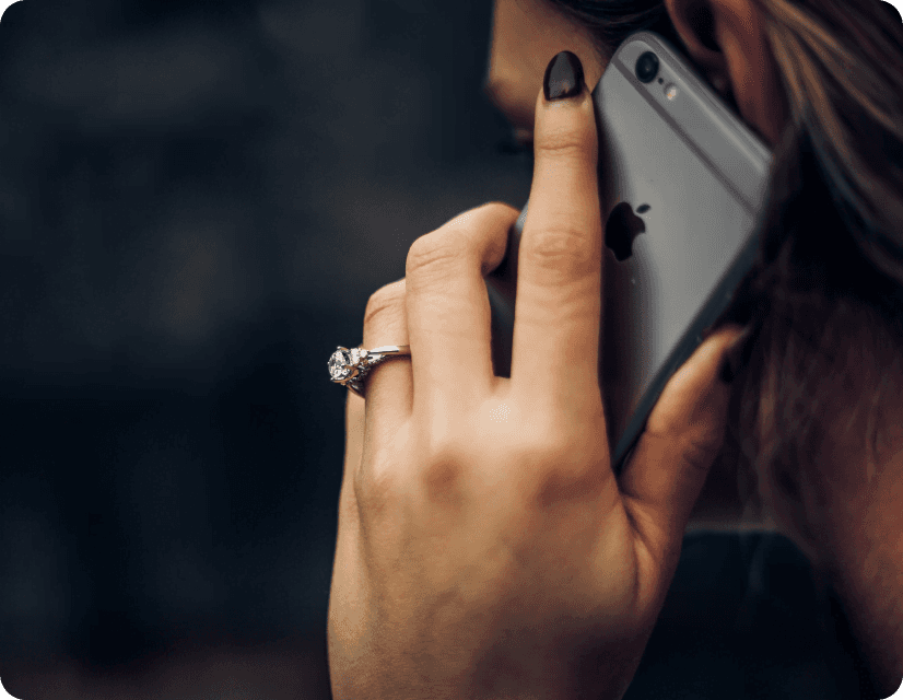 Women calling with an iPhone, wearing a diamond ring.
