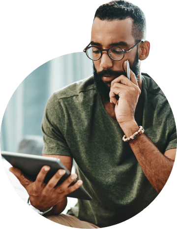 A man is sitting and watching the tablet screen.